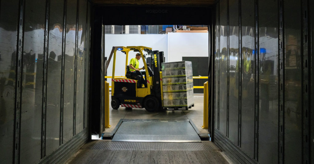 Worker transporting packages on a forklift | Forklift Accidents