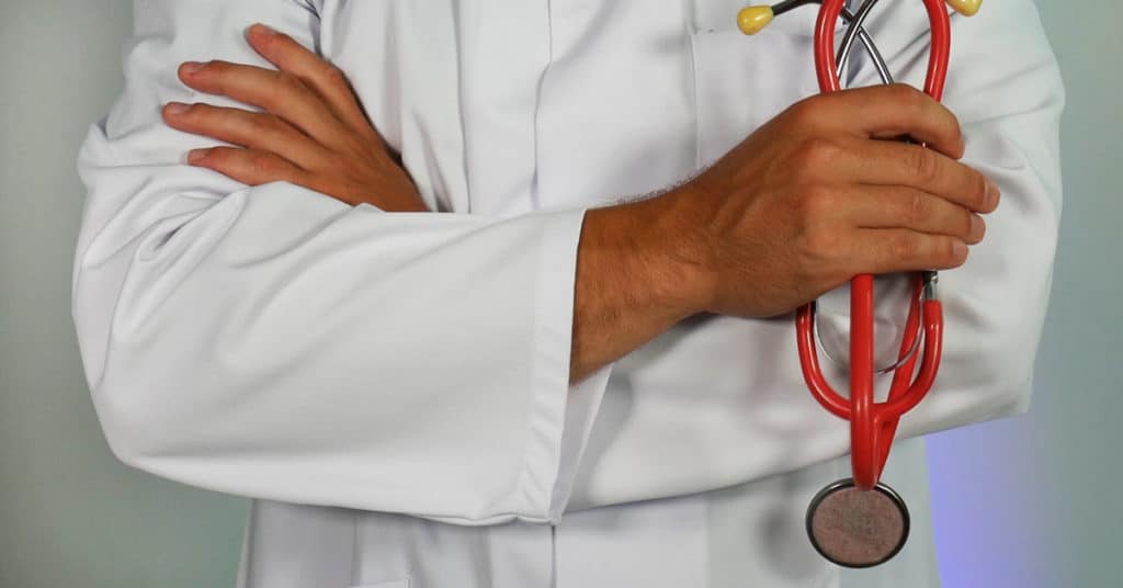 Doctor holding stethoscope | Workplace Injury