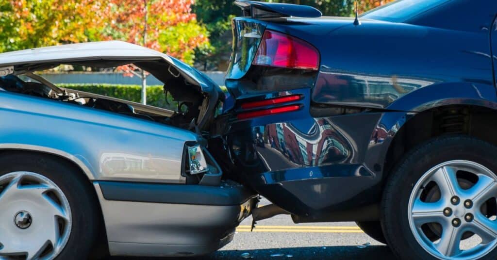 A car accident left the front engine of a sedan smushed and the back tailgate of a larger sports car crumpled, Do I Need a Personal Injury Lawyer