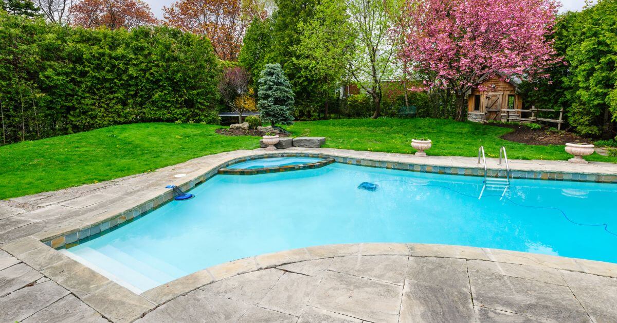 An in-ground swimming pole with stone pool deck in a wooded Pennsylvania area, summer injuries, personal injury attorneys