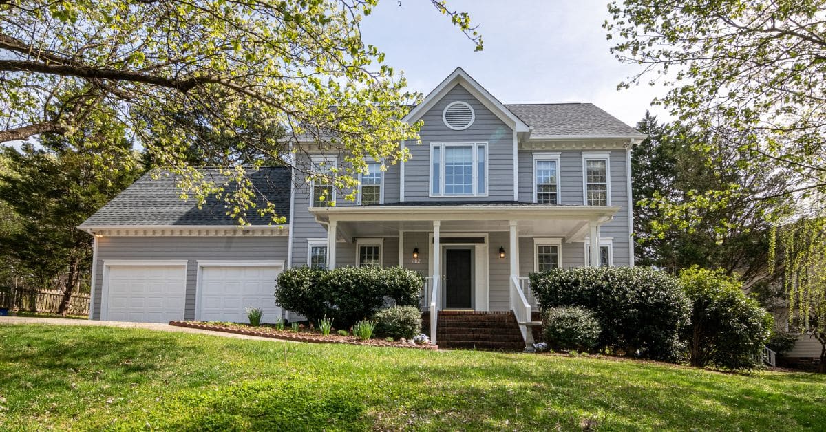 Front view of the outside of a nicely landscaped two story home with an attached garage, Common Estate Planning Mistakes