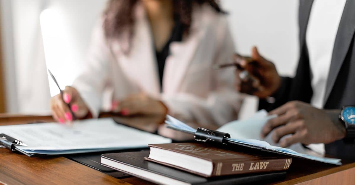 A man and a woman sitting at a table reviewing paperwork, Mistakes to Avoid in Estate Administration