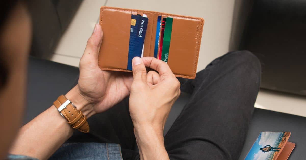 Man holding a leather wallet with credit cards, Debts and Liabilities During Estate Administration