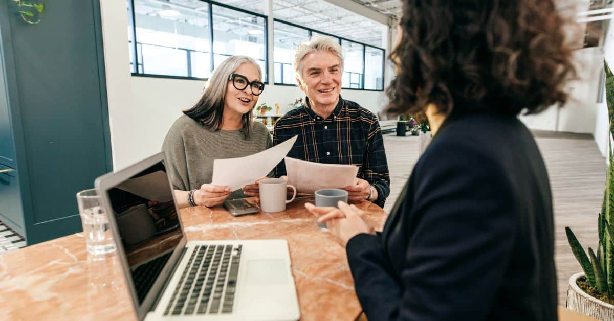 Couple holding papers talking to an estate planning lawyer, Digital Assets in Your Estate Plan