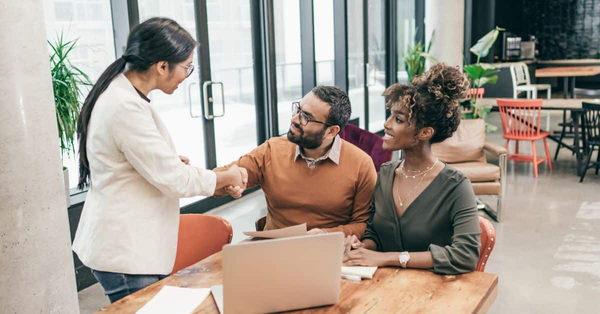 Man and woman smiling and shaking hands with a woman, Review Your Estate Plan