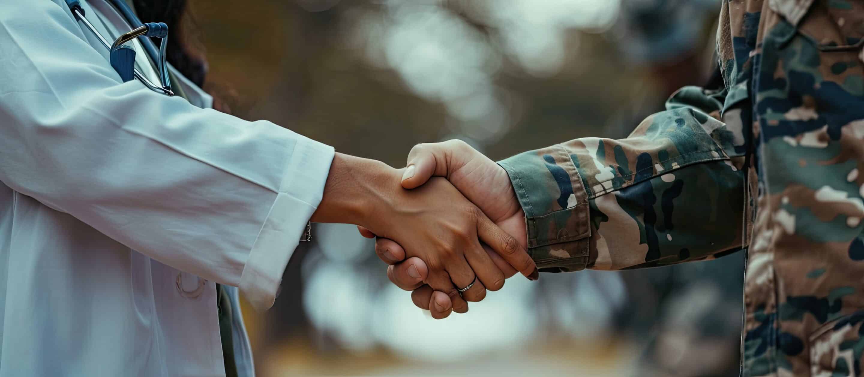 Happy military man shaking hands with female doctor while being with his wife at medical counselling. Copy space image. Place for adding text